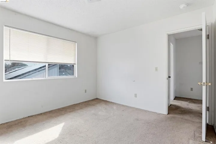 Spare room featuring carpet flooring and a textured ceiling