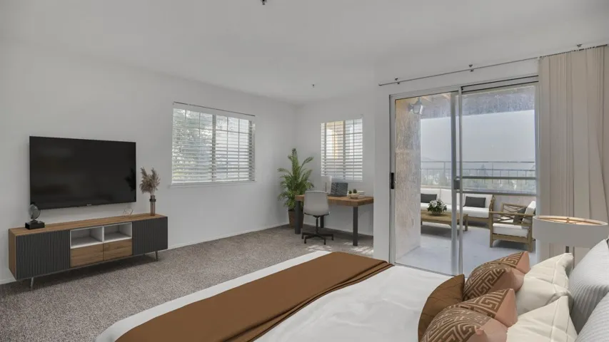 Bedroom featuring carpet, an office area, and access to exterior