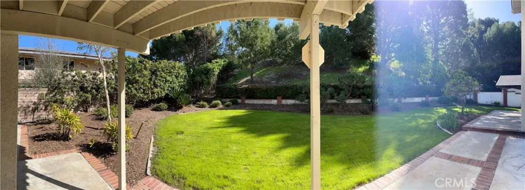 Panoramic view of the yard just outside the sliding glass doors of the master bedroom