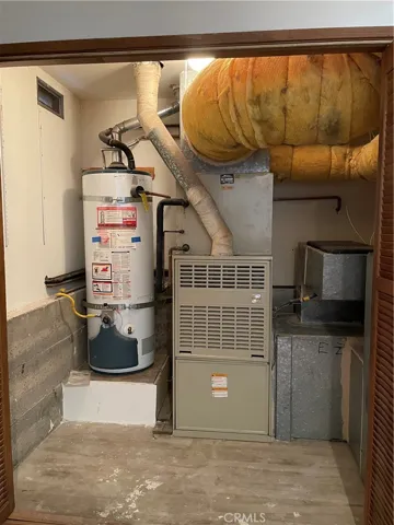 Strapped gas fueled water heater