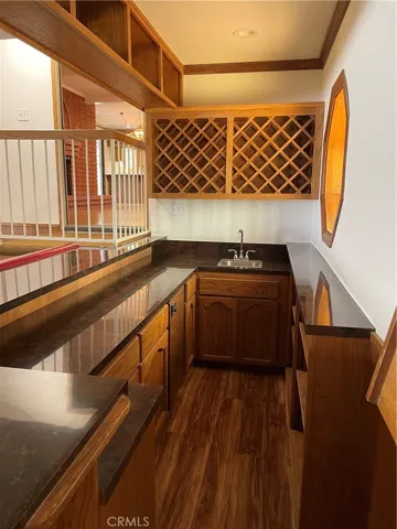 Bar comes equipped with working faucet and wine racks