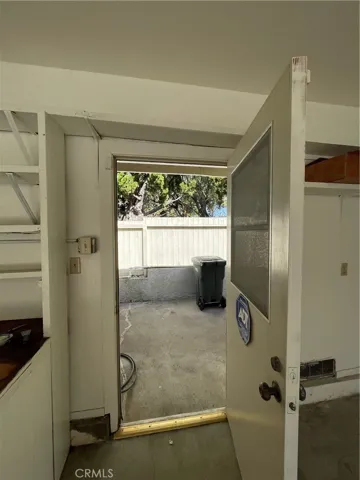 Garage leads to landscaping storage area through a door