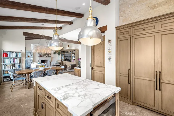 The living, dining, and kitchen areas are unified by abundant natural light and uninterrupted ocean vistas, creating an inviting setting for everyday living and memorable occasions alike.