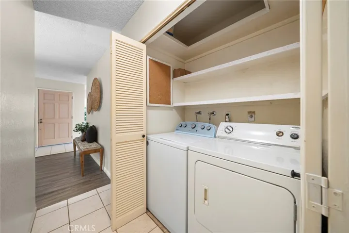 Hallway Laundry Closet with Newer Washer and Gas Dryer Included.
