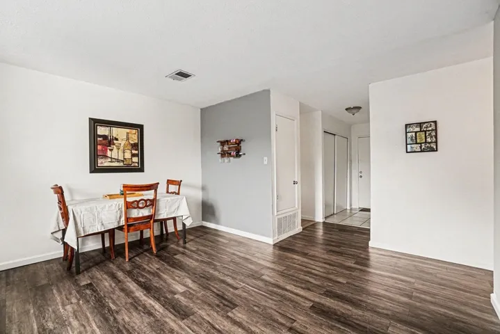 Dining area featuring dark wood finished floors and baseboards