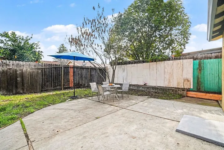 Fenced backyard with a patio area and outdoor dining area