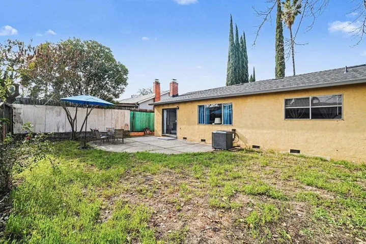 Back of house with a patio area, a fenced backyard, stucco siding, and crawl space