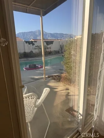 Primary Bedroom overlooking pool with view