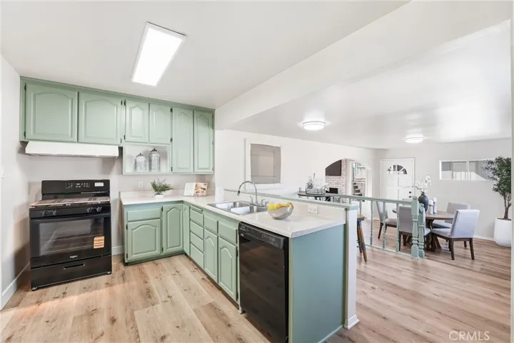 Freshly painted kitchen with ample countertop space, NEW freestanding gas range, stainless steel sink, and open to the dining and family rooms!
