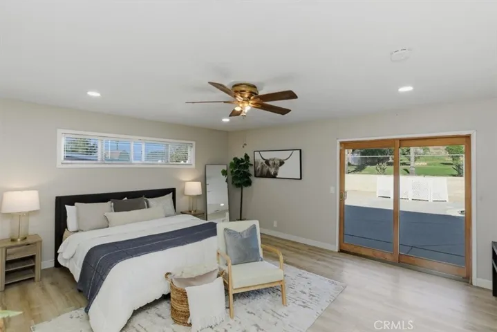 Primary bedroomw ith sliding doors to the pool area and backyard