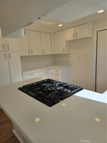 Kitchen viewed over peninnsul from barstool area