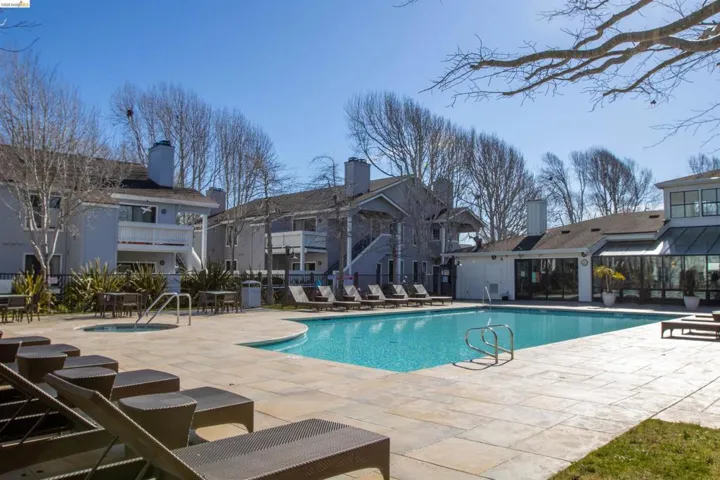 Community pool with a patio