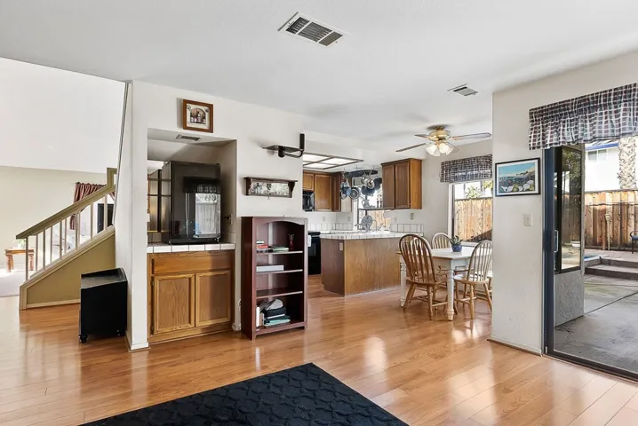 Living room featuring light wood-style floors and a ceiling fan