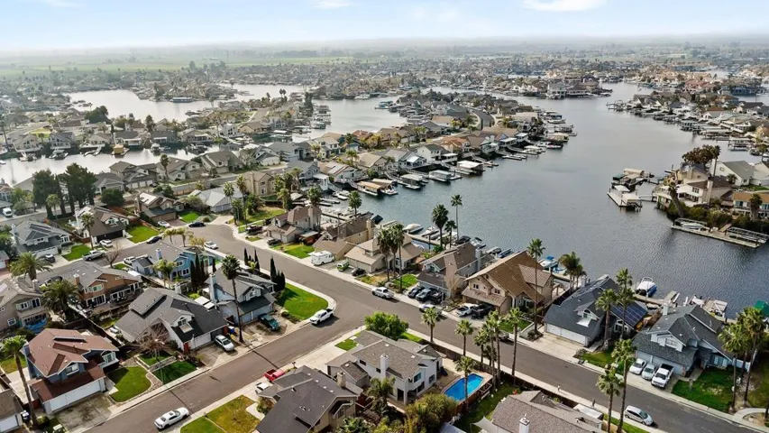 Aerial overview of property's location with a large body of water and nearby suburban area