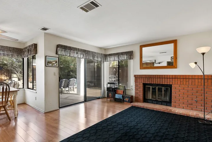 Living room featuring wood finished floors and a fireplace