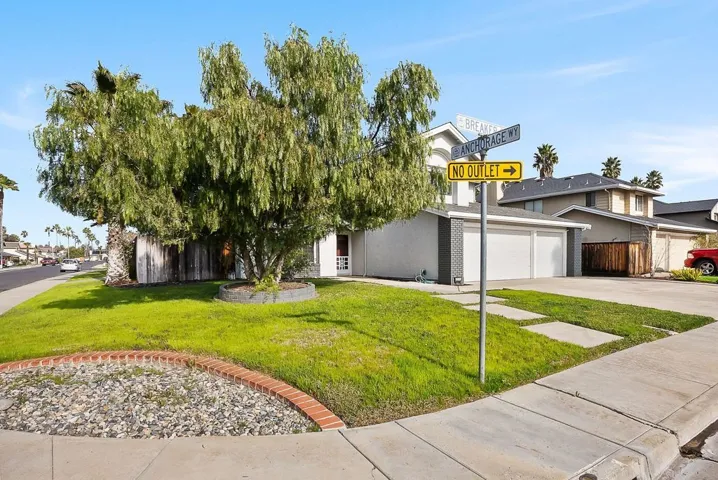 View of front of house featuring concrete driveway and a garage