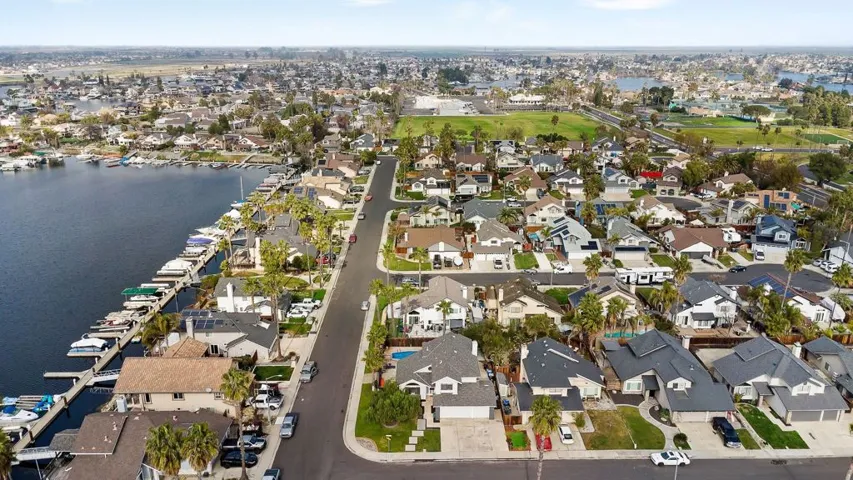 Aerial overview of property's location with a nearby body of water and nearby suburban area