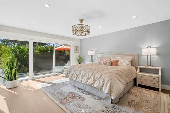 Expansive primary suite filled with natural light, offering direct access to the private patio and peaceful garden views.