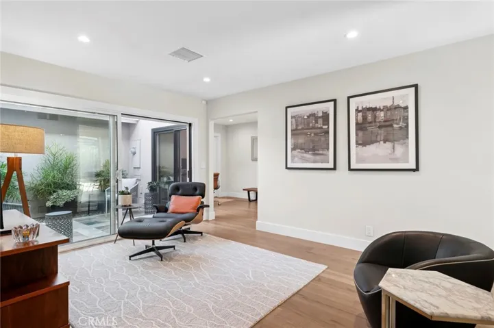 Sunlit living space featuring expansive glass doors that frame garden views and enhance the home’s indoor-outdoor flow.