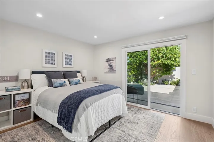 Spacious bedroom retreat with direct access to a private patio, offering peaceful garden views and abundant natural light.