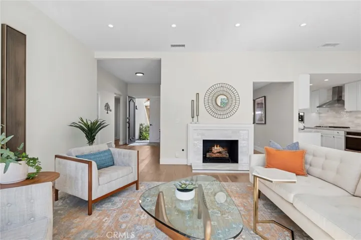 Comfortable living room centered around a stylish fireplace, ideal for relaxing or entertaining guests.