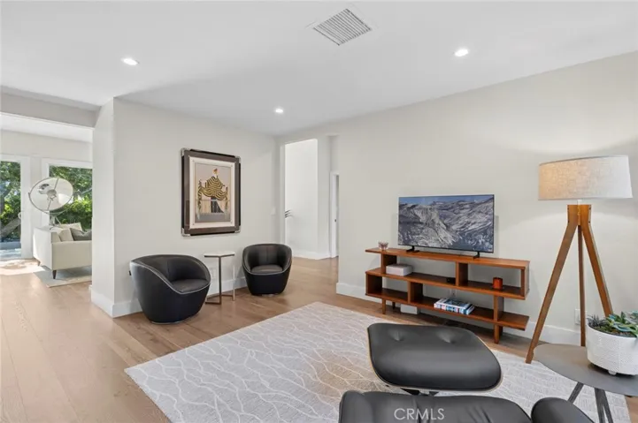 Versatile living space ideal for a home office, media room, or additional lounge area with patio access and abundant natural light.