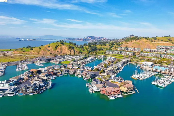 Bird's eye view of numerous boat docks and a water and mountain view