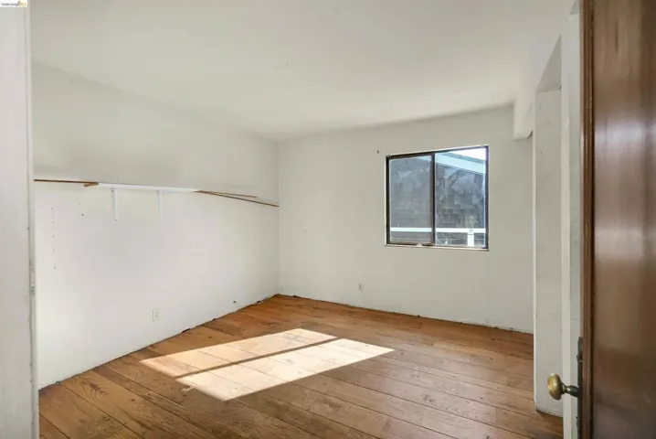 Unfurnished bedroom with light wood finished floors