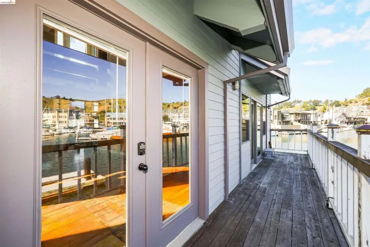 Balcony with a water view and french doors