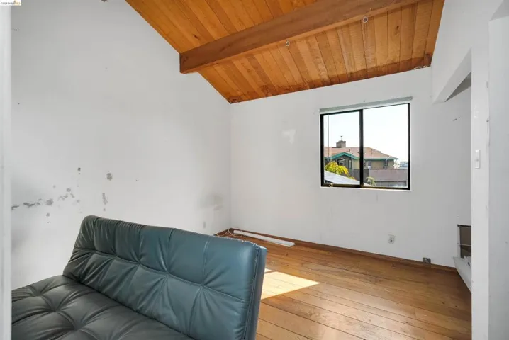 Living area featuring wood ceiling, vaulted ceiling with beams, and hardwood / wood-style floors