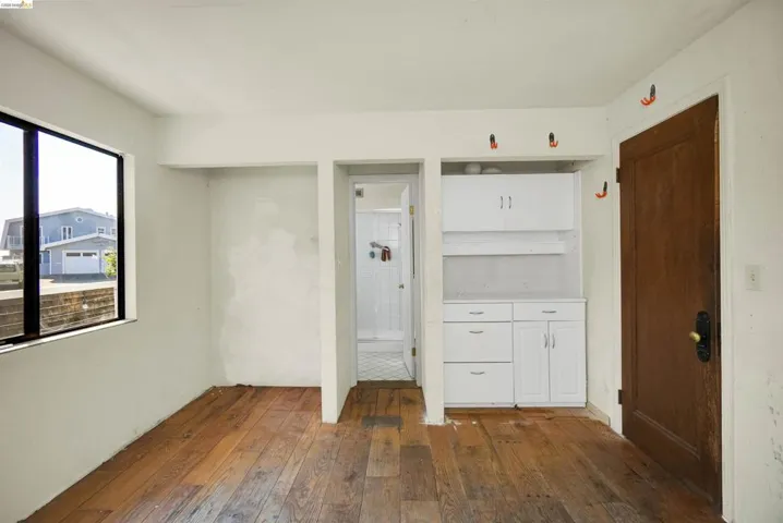 Interior space with dark wood finished floors and ensuite bath