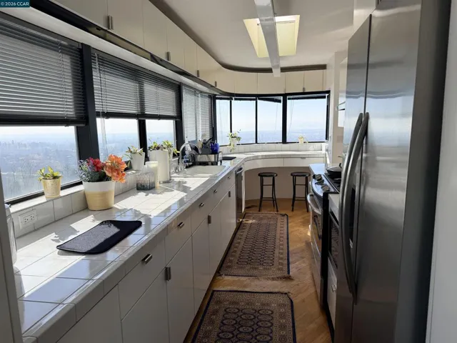 Chef's kitchen with all new appliances, breakfast bar, and stunning views