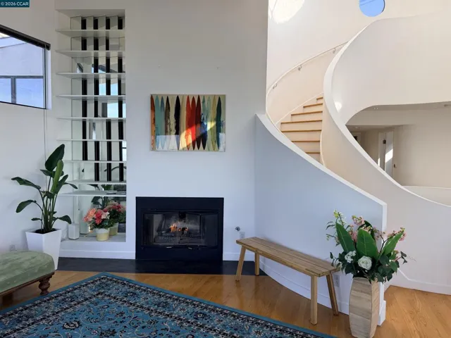 Relax by the fireplace in this modern home with beautiful views of the Bay