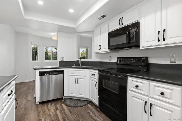 Walk through kitchen with dining room on one end and breakfast nook on the other.