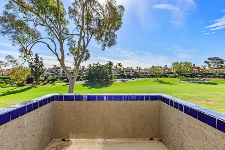 Balcony off primary bedroom with panoramic views of golf course.