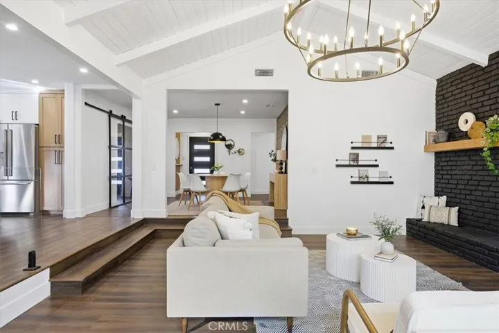 Vaulted ceilings and brick fireplace (decoration only) in living area