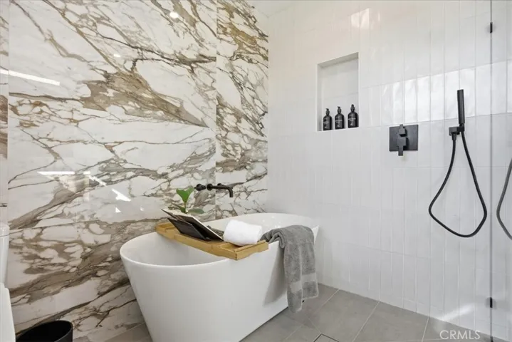 Spa like primary bathroom with large soaking tub and walk in shower