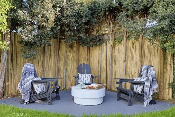 Large backyard has outdoor firepit and paved patio area great to relax and make smores