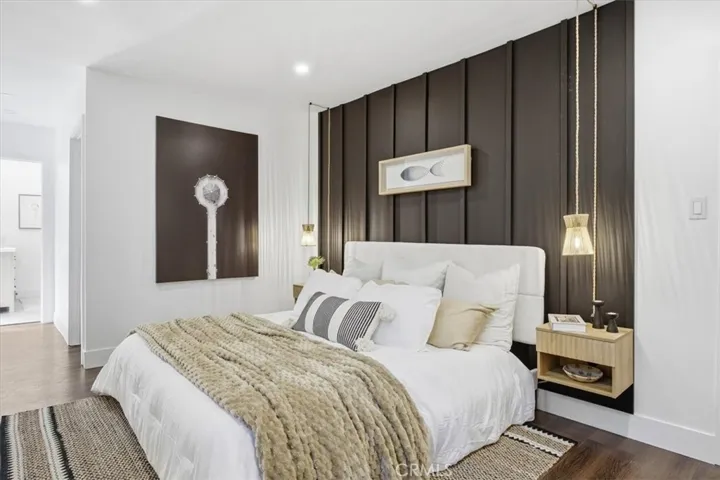 Primary bedroom with built in bedside tables and side lights, walk in closet