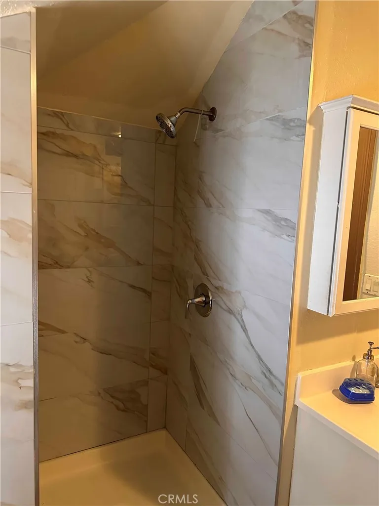 View of shower in front unit. All 4 units have updated bathrooms.