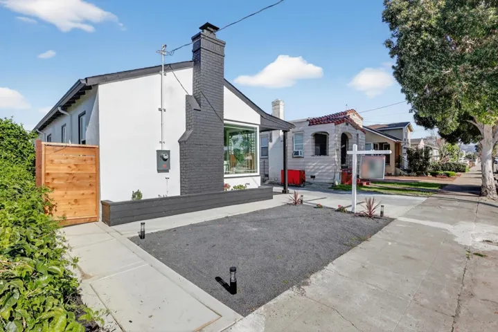 View of property exterior featuring stucco siding and a chimney