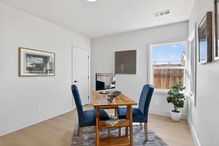 Dining room with light wood-style floors and a desk