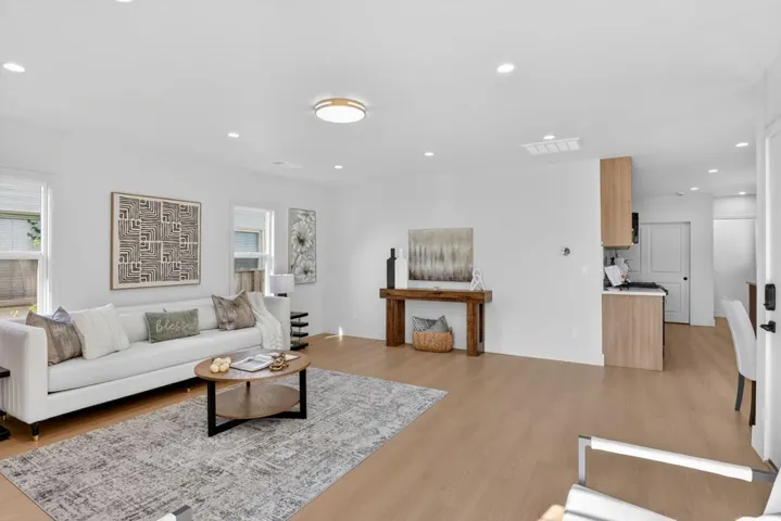 Living room featuring light wood-type flooring, recessed lighting, and plenty of natural light