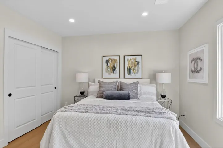 Bedroom with light wood finished floors, recessed lighting, and a closet