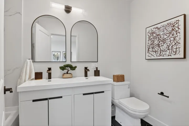 Bathroom with double vanity and toilet