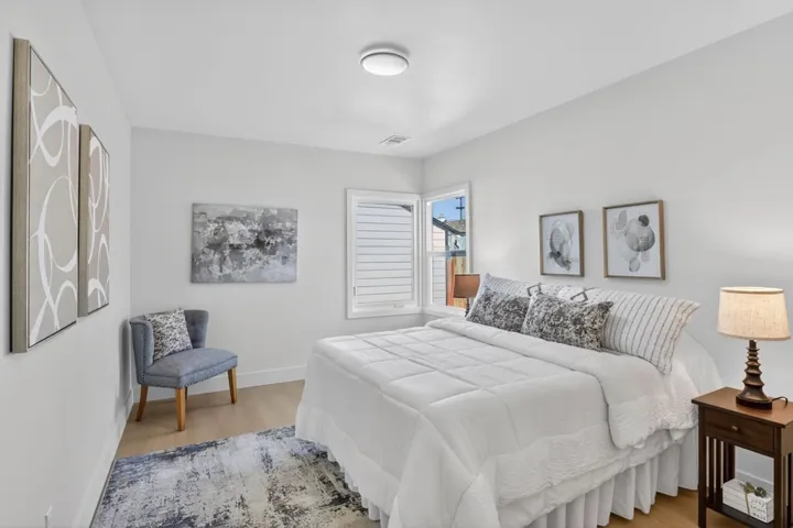 Bedroom with wood finished floors and baseboards