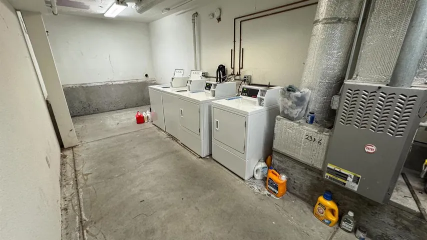 Community laundry featuring heating unit and washer and dryer