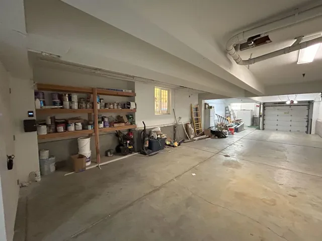 Garage featuring freestanding refrigerator