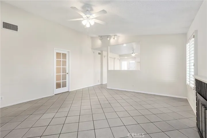 Living room with gas fireplace, vaulted ceiling, and open to kitchen