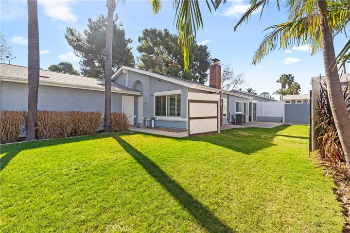 View of front and side yard with gate open